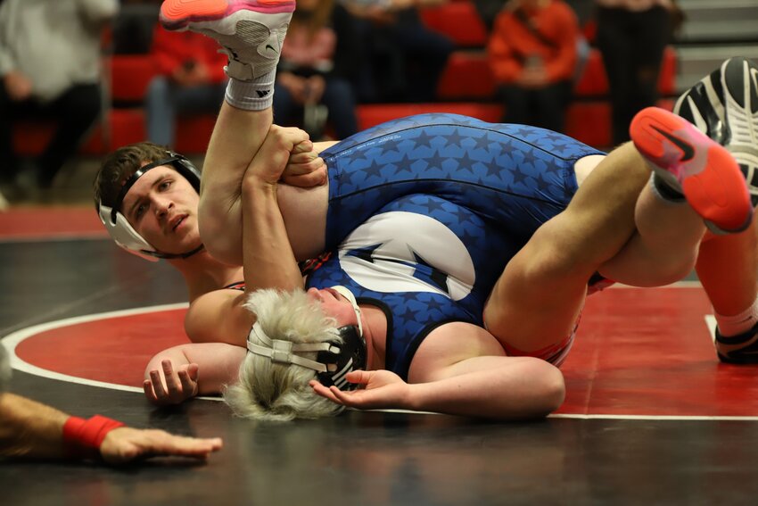 Sherwood junior Eli Ferrell pins Holden’s Vince Vance during the first day of the Class 1 District 2 Tournament in Butler. Ferrell won the 190-pound bracket, becoming a three-time state qualifier.