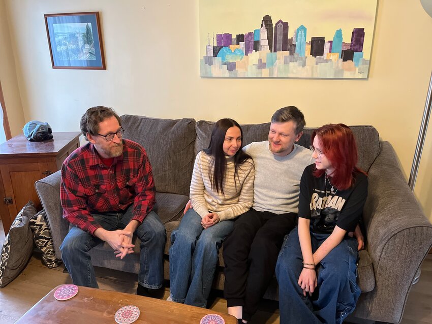 Adrian alderman Matt Sears, left, converses with the Borovyk family, Lesia, Andrii and Dacha. The Borovyks are approved refugees from Ukraine, having fled the war zone.