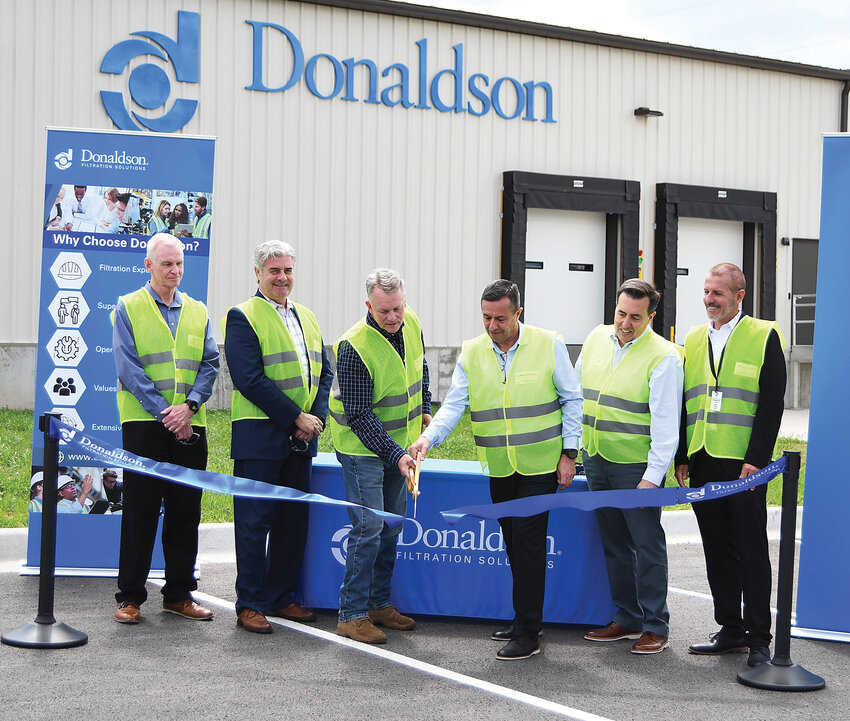 Officials from the city of Harrisonville and Donaldson held a ribbon cutting last week for the expansion of the company’s Harrisonville plant. Donaldson doubled the size of the plant with the project. Pictured, from left, are Harrisonville Economic Development Director Jim Clarke, Harrisonville City Administrator Brad Ratliff, Harrisonville Mayor Mike Zaring, Industrial Solutions President Guillermo Briseño, Donaldson Sales Director John Falk and Industrial Air Filtration Vice President Mauricio Goes.