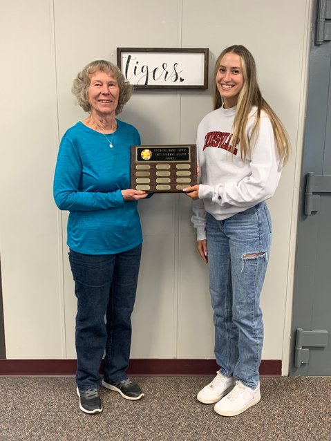 DeltaDelta's Delores Currier, left, and Mika Schultz, right, hold the plaque that will now bear Schultz's name as the organizations Outstanding Senior Youth Award winner for 2023.