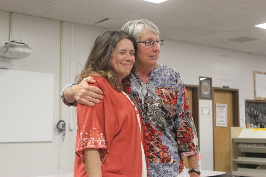 Amy Wartman and Stacy Gee share a hug at the site council meeting April 18. Wartman will be taking Gee's place at the helm of Kepley Middle School.