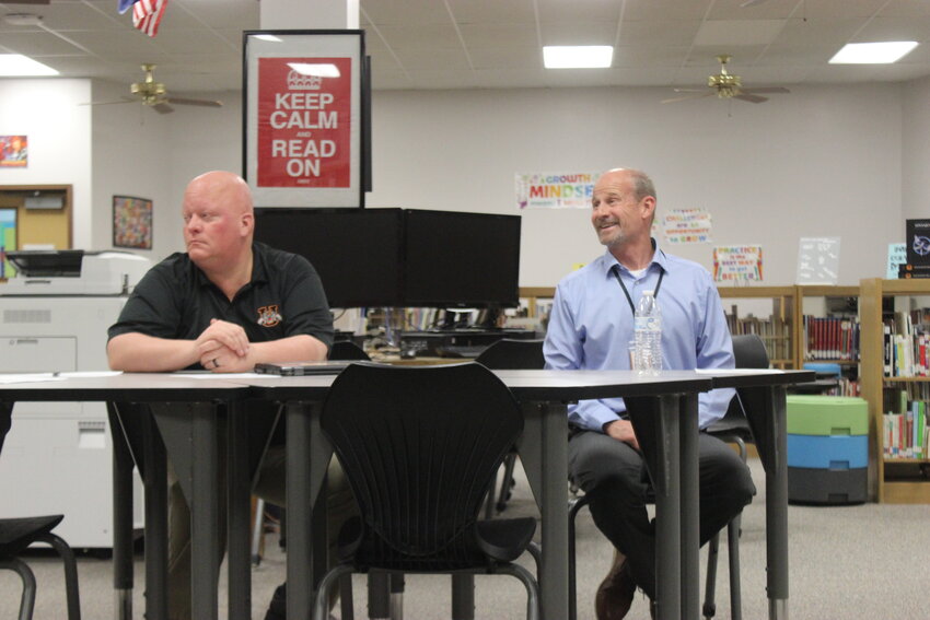 (Left to right) Assistant Principal Kevin Self and USD214 Superintendent Corey Burton look on as outgoing Kepley Middle School Principal Stacey Gee and incoming Principal Amy Wartman share information on CTE program.