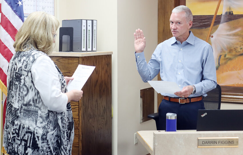 Darrin Figgins is sworn in as District 1 county commissioner by county clerk Sheila Brown on October 1.