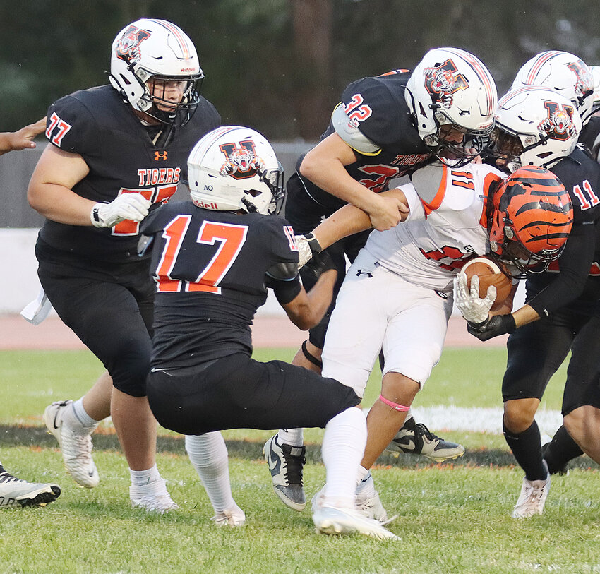 Ulysses defenders Brody Britton (77), Julian Meraz (17), Stryker Berglund (32) and Parker Browning (11) gang up on Guymon running back Isaiah Dunnagan (11) during last Friday’s homecoming contest at Maxwell Field.