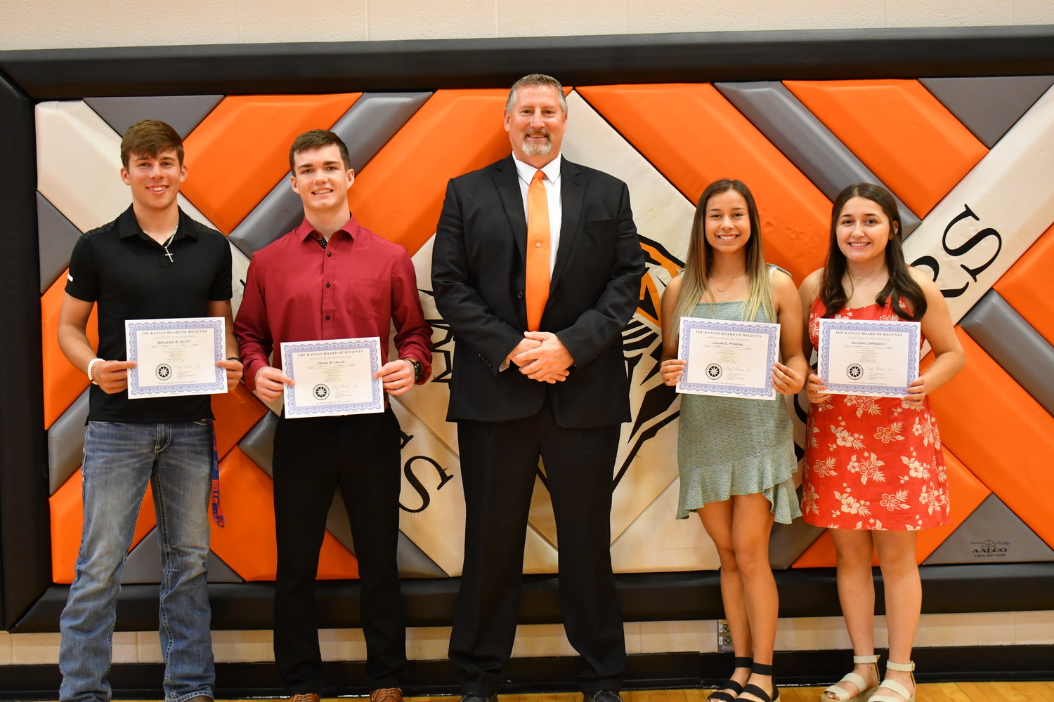 Senior Awards — Ben Scott, Devin Delay, Laura Porras, and Valeria Carrasco were given the Kansas State Board Curriculum Completers Scholarship from Mark Paul on Friday, May 13, 2022.