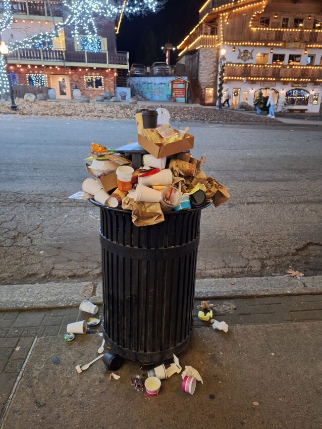 Overflowing public garbage bin on Front Street during an unexpectedly busy weekend in late November 2023.