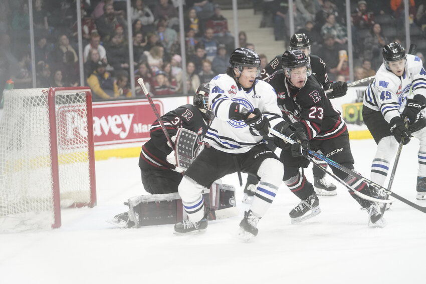 Wenatchee Wild forward Kenta Isogai (86) battles for a spot in front of the Red Deer Rebels’ net in Wenatchee’s 3-2 win over the Rebels Saturday. Isogai’s third-period goal was the eventual game-winner as the Wild picked up their 30th win of the season.