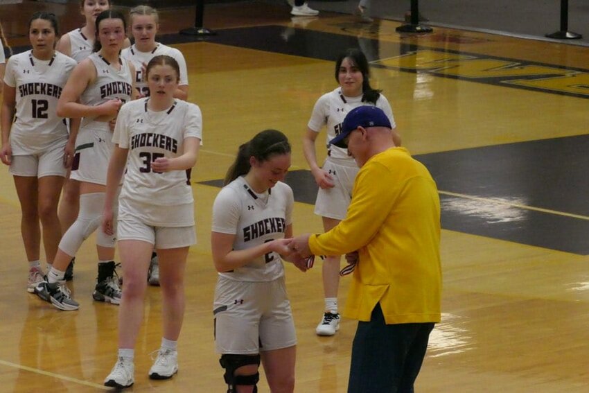 Senior Tiera Miller accepts the sportsmanship award following Waterville-Mansfield’s win over Oakesdale.