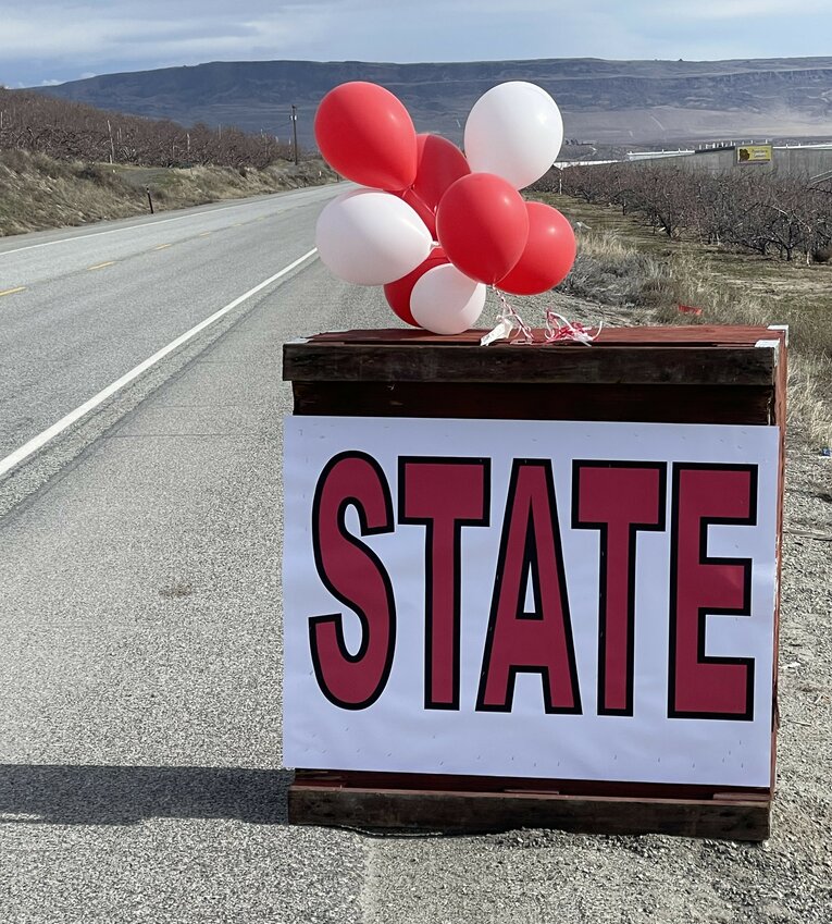 One of several Bears booster signs decorates an apple bin along Highway 97 headed east toward Spokane.