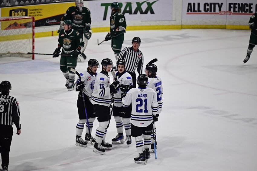 Wenatchee Wild players gather to celebrate Briley Wood’s goal in the first period of Saturday’s Western Hockey League game at the Everett Silvertips.