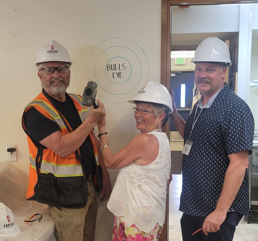 Heritage Heights board members are shown with the Bull’s Eye, where the kitchen remodel will begin at the ‘groundbreaking’ held on May 15. Front row,  left to right: Leslie Meyers (secretary) and Susie Hepner (vice-chair); back row, left to right: Melissa Robins (board chair),  Steve Firman (treasurer), Sharon Lukacs, and Bruce Bain. Board members not shown are Sally Harper, Dr.Dan Weakly and Matt Russell.