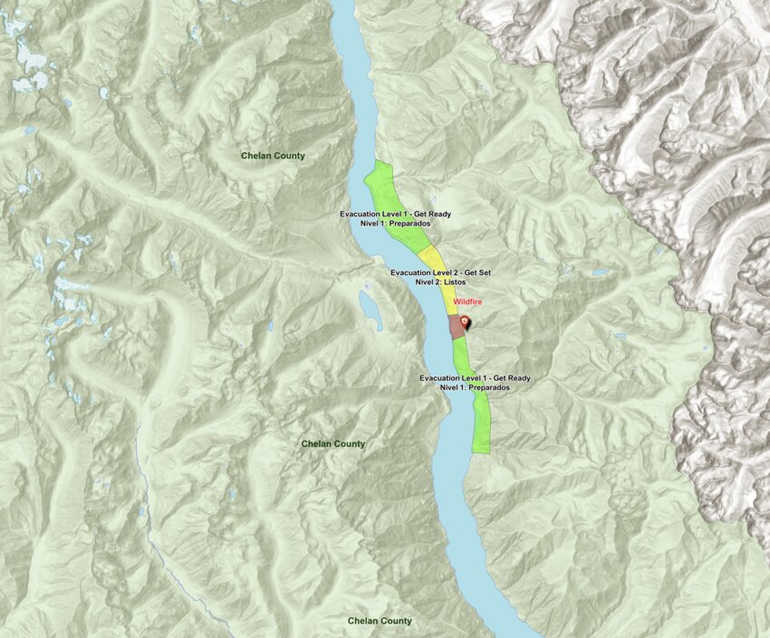 A map shows the location of the wildfire on Lake Chelan's north shore, along with the three evacuation levels in place for nearby areas as of June 14. Chelan County has declared a state of emergency in response to the fire, which has burned over 1,700 acres since June 8 and remains uncontained.