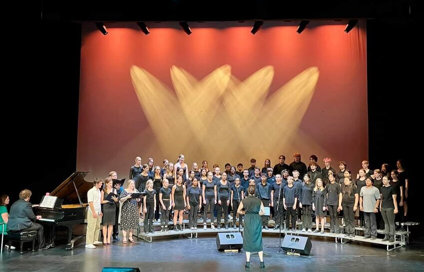Isabella Garcia leads an ensemble of soloists, accompanists, and choristers in the finale performance of the Cascade Choir Crescendo Campaign at Snowy Owl Theater on July 11.