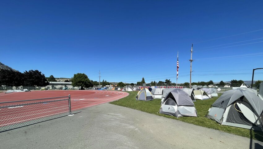 Tents dot the north end of the Brewster High School football field.