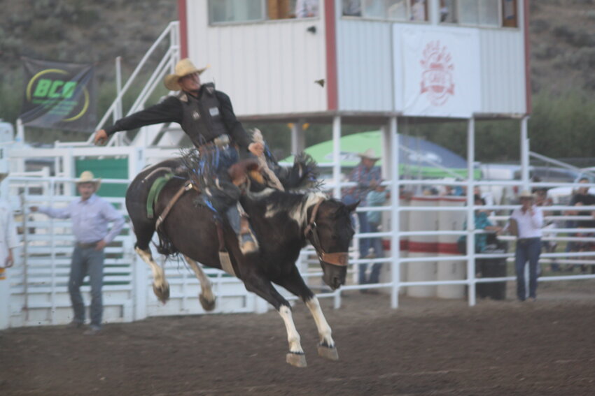 A cowboy competes in saddle-bronc riding at a previous Lake Chelan Pro Rodeo. This year's event, scheduled for July 19 & 20, will feature similar high-energy rodeo action with over 100 contestants expected to participate.