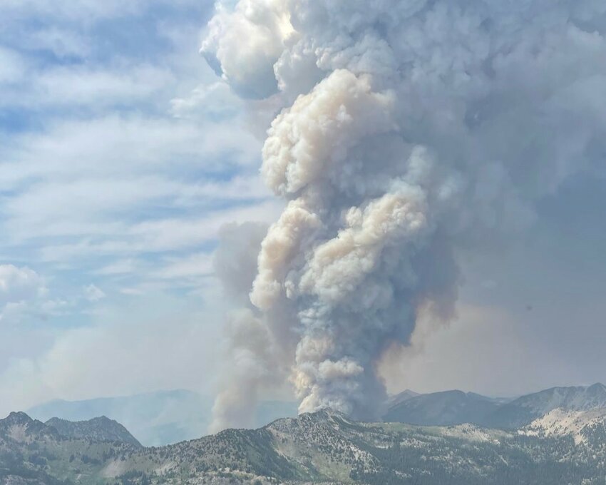 A massive plume of smoke rises from the Pioneer Fire in the rugged terrain of Fish Creek on July 17.