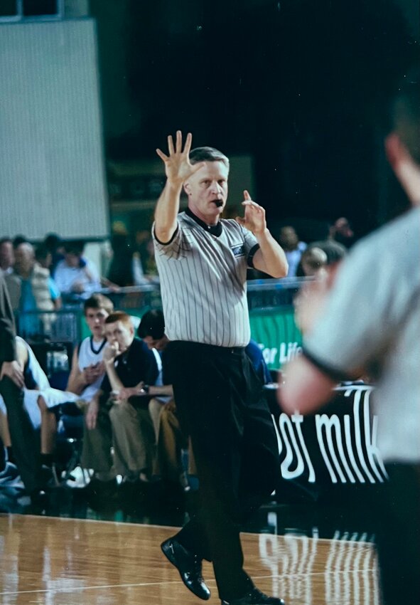 Steve Simonson signals a call during a basketball game in the 1990s, showcasing the dedication that led to his upcoming induction into the Washington Officials Association Hall of Fame.