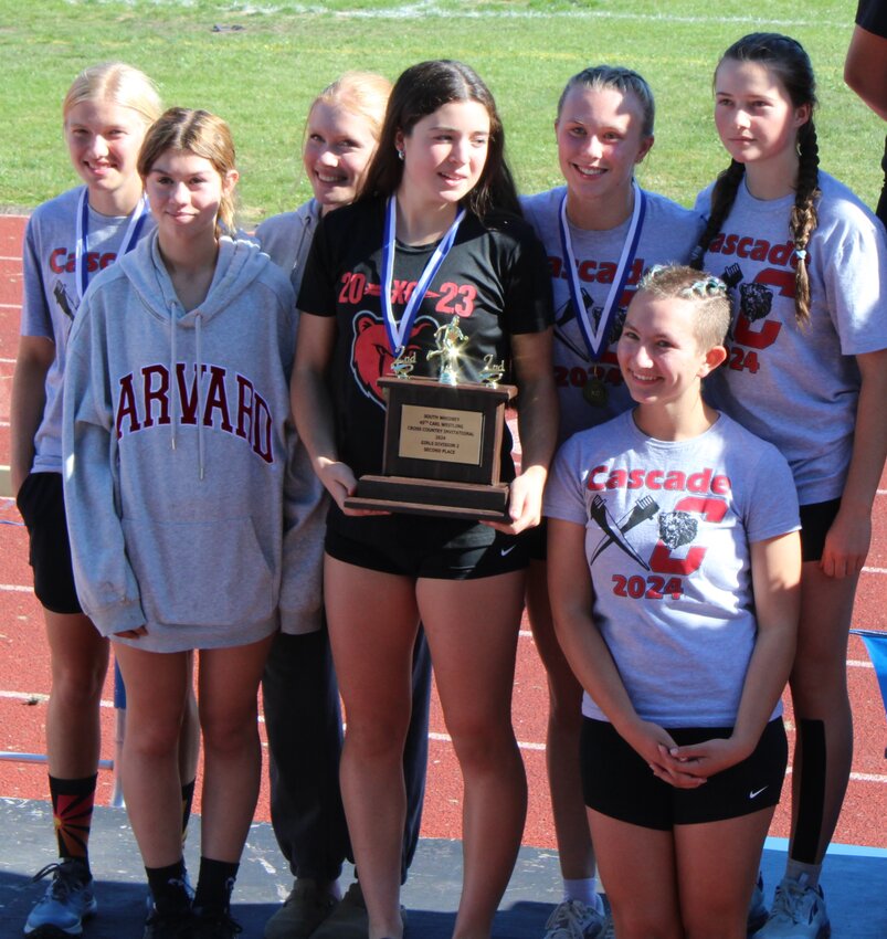 The lady Kodiaks varsity team takes to the podium on Whidbey Island with their second-place trophy.