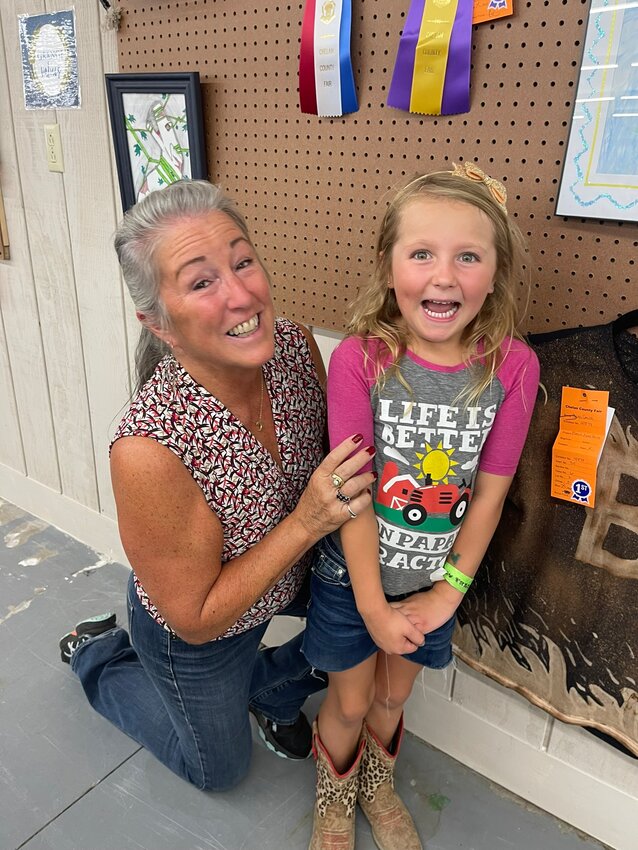 Kim Ustanik is pictured with her granddaughter Kenna Hie. Hie, a member of Manson Grange Youth Fairs, participated in the Chelan County Fair for the first time this year.