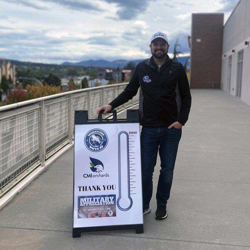 Wenatchee Wild Senior Sales and Operations Coordinator David Rayfield poses on the balcony at Town Toyota Center ahead of his annual Military Appreciation Campout in 2023. The Wild announced Wednesday that Rayfield’s campout will return on Monday, October 21. Rayfield will camp on the balcony at Town Toyota Center in Wenatchee until he has sold 1,000 tickets to the team’s Military Appreciation game on November 9.