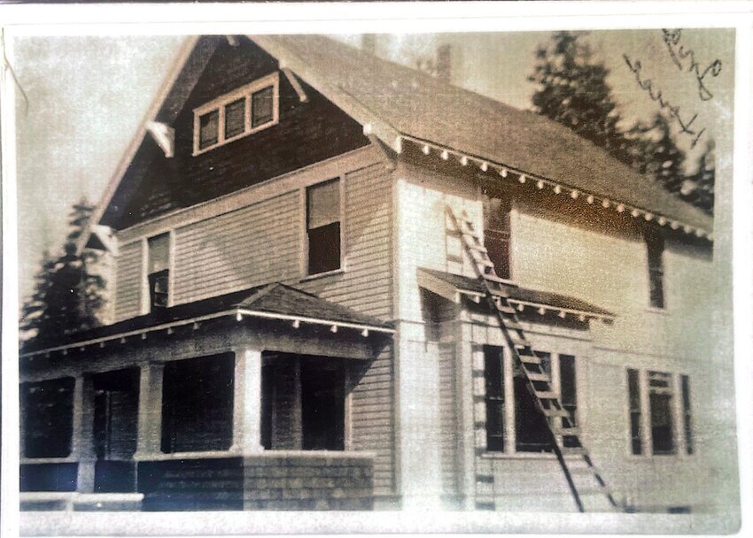 Karen Dickinson and Bill Burgess stand in a home built by Burgess’s great-grandfather in 1914.