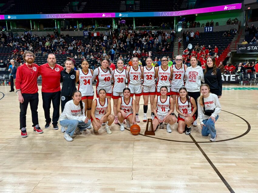 The Brewster Lady Bears hold their sixth-place state trophy.