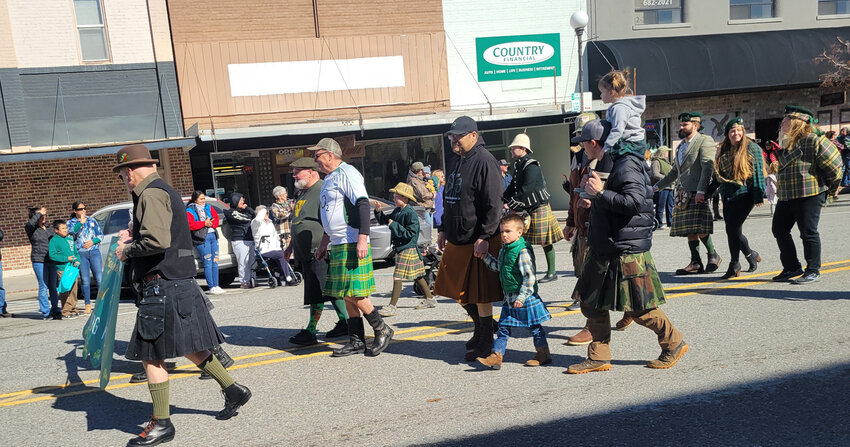 Leading the Wayne Kelly Memorial St. Patty’s Top Dog Parade was Pat Kelly (on the left) holding the banner for the parade which honors his father, Wayne Kelly. He was joined by many in the wearing of the plaid and kilts.