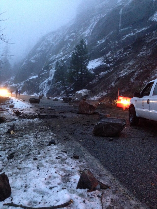 Rockfall debris blocks a section of Icicle Road #7600 near Leavenworth during wintry conditions on December 8, 2014. Boulders and rocks litter the roadway as emergency vehicles respond to the hazard. The upcoming repair project, scheduled to begin April 7, will address chronic rockfall issues and road damage along this steep mountain corridor.