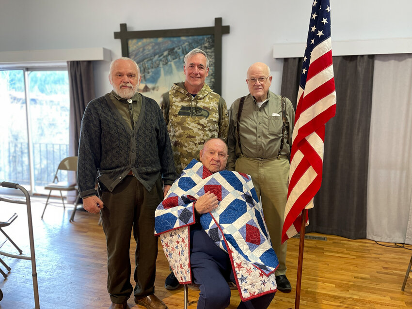 Veterans Larry Shannon, Mike Worden, and Paul Gray stand behind retired U.S. Air Force Major Fred Shannon.