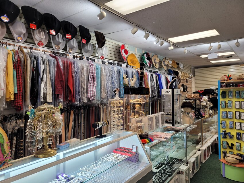 Jewelry, belts, hats, and more accessories run along the counter beside the cash register.