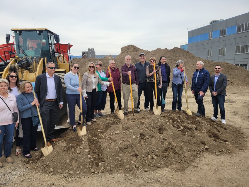 Youngsters from the YMCA grab shovels and get to “work” at the groundbreaking ceremony.