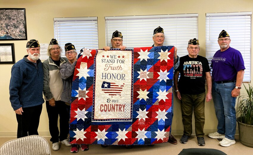 Jim Taylor received a Quilt of Valor during March 8 ceremony held at Lake Chelan Winery: Left to right are: Craig Pittson, Carole Hanson, Marie Cannon, Doug Marsh, Jim Taylor, Brian Strausbaugh and Robin Bloch.