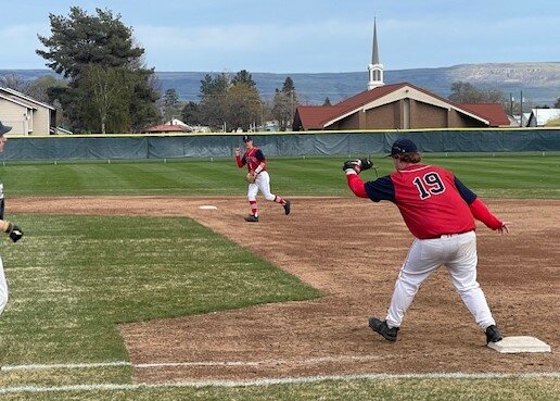 Bears first baseman Will Reynolds easily beats a Meridian base runner barely visible at left during a non-conference game against the visiting 1A Trojans last Thursday, April 10. Meridian won the game. 6-2.