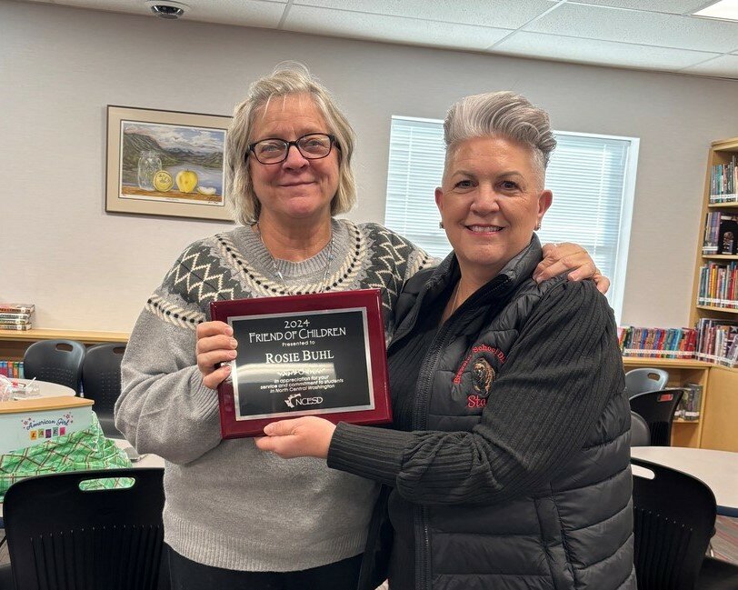 Rosie Buhl, left, accepts the Friend of Children award from Brewster School Superintendent Lynnette Blackburn for her extraordinary support and dedication to students in need over the past 20 years. Buhl purchases dolls for students in need and personally delivers them to schools in the area. Her network of friends, skilled in sewing and knitting, contribute by creating clothes, blankets, and other items, enhancing the experience for the children who receive the gifts. Each doll is uniquely themed, ranging from cowgirls to firefighters, adding a personal touch to every delivery. The Friend of Children award was created in 1992 to recognize outstanding volunteers in the communities represented by the districts within the North Central Educational Service District’s four-county region. Recipients of the award make extraordinary contributions to local schools, not for fame or notoriety, but because that is simply who they are as a community member.
