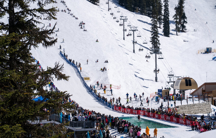 Skiers and snowboarders celebrate the close of winter with a pond skim at the base of Showcase during the annual Stevens Pass Spring Fest.