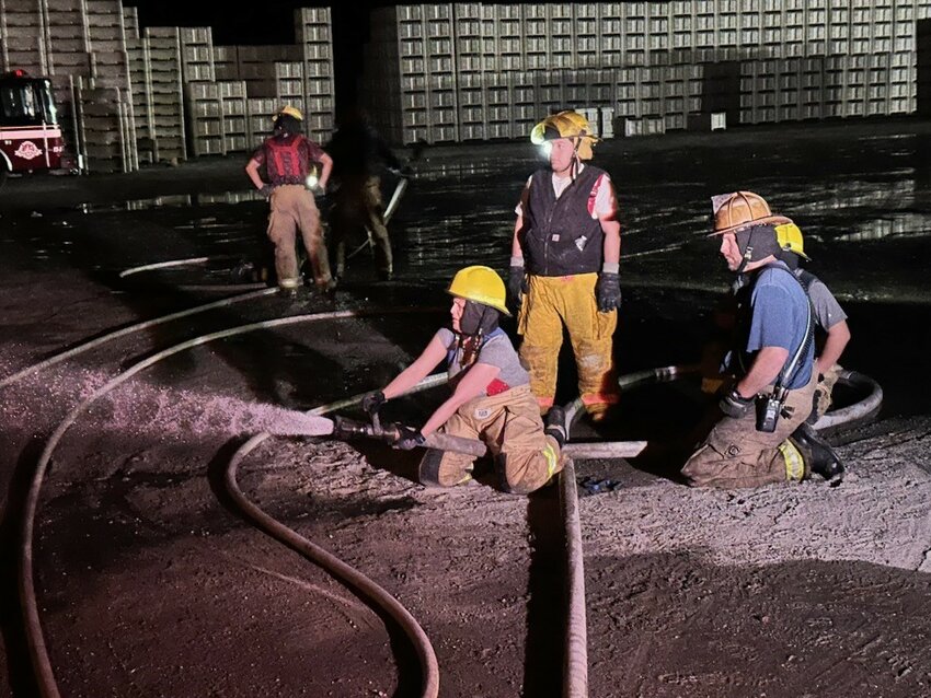 Recruits man a fire hose during a night training exercise in Pateros last month.