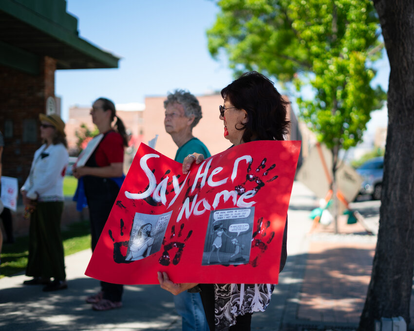 Marchers gather in a circle in Centennial Park on Monday afternoon.