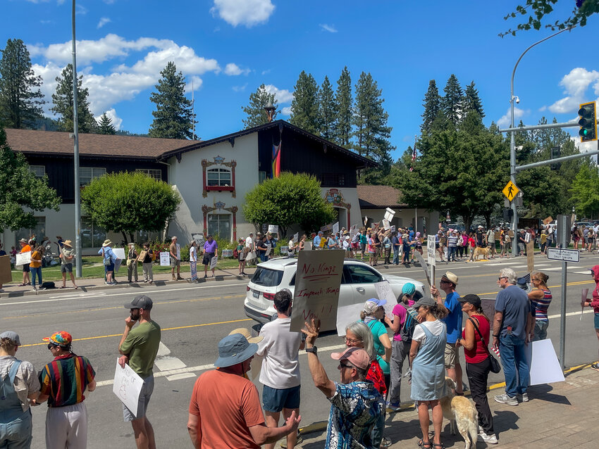 Protestors stand in front of Leavenworth CIty Hall during the “No Kings” protest. Many protestors wished to not disclose their names at the rally.