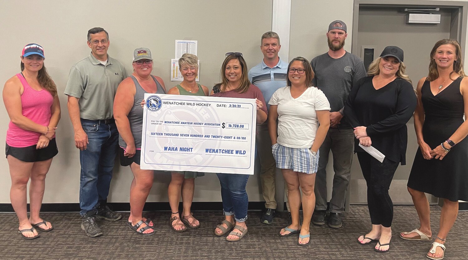 Wenatchee Amateur Hockey Association members and Wenatchee Wild staff pose at a recent check presentation. The Wild announced more than $215,000 in charitable contributions, covering the time during and immediately after the 2022-23 season.
Courtesy WAHA/Wenatchee Wild