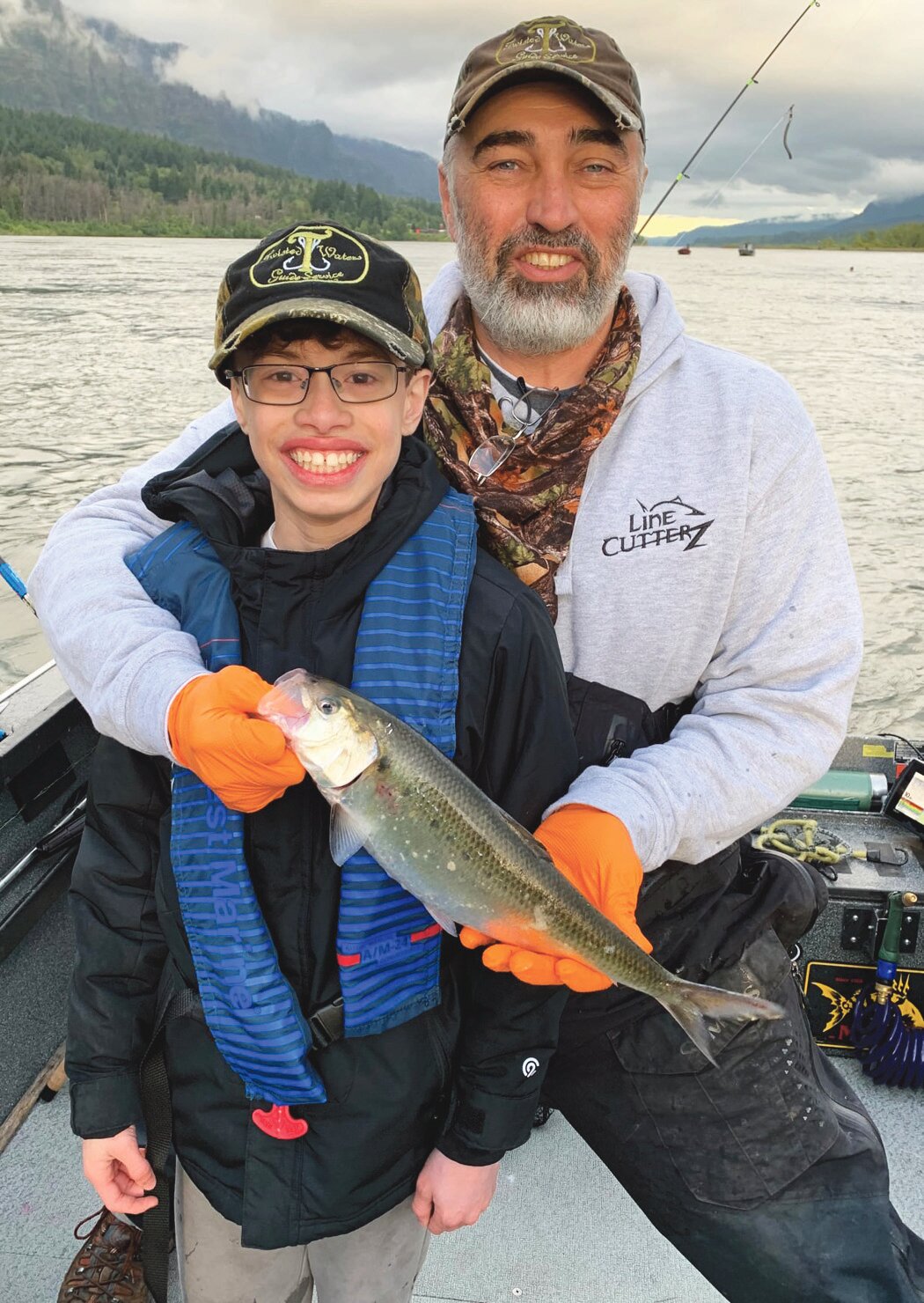 Marc Bush and a happy client with an American shad
Courtesy M. Bush