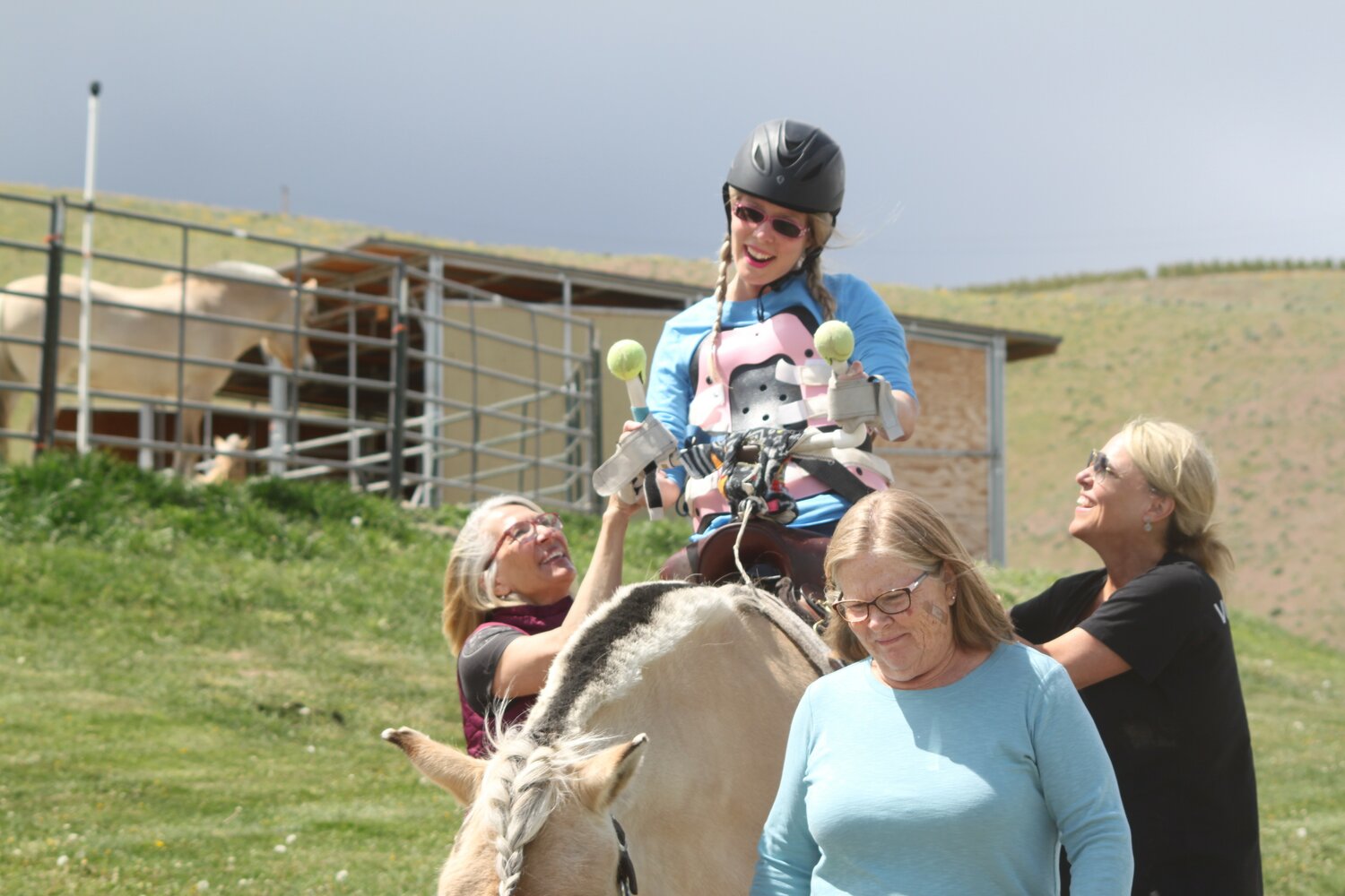 From left, Nancy Grette, Laurie Steward, and Susan Wall assist Crystal Chevelle as she rides 
her horse Frid during a session at Alatheia Therapeutic Riding Center in Wenatchee. 
Photo by Matthew Ockinga