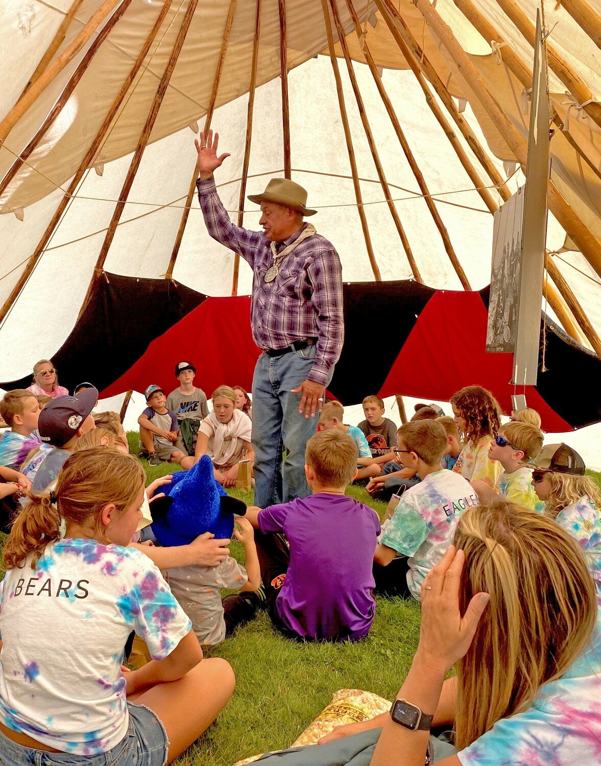 Roger Amerman of the Choctaw Nation presented a series of historical photographs that show the significance of the Native American long tent as the center of tribal community. In this photo, Amerman is discussing the East-West orientation of the long tent to a classroom from Roots Community School from Chelan. It was one of several learning stations students visited during the 30thannual Wenatchee River Salmon Festival Sept. 15-16.
By Rachel Hansen
Senior Communications Strategist, CC PUD