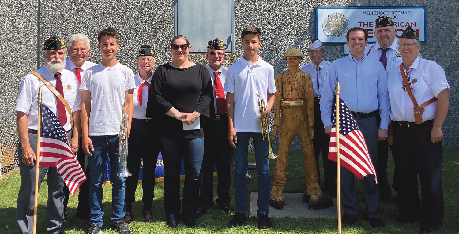 Left to right: Craig Pittson, Norm Manly, Rex Torgesen, Marie Cannon, Tiffany Gering, Brian Strausbaugh, Lucas Torgesen, Kathy Seureau, Manson School District music teatcher Matt Brown, Clyde McCullough and Carole Hansen. Rex and Lucas played taps during the ceremony.