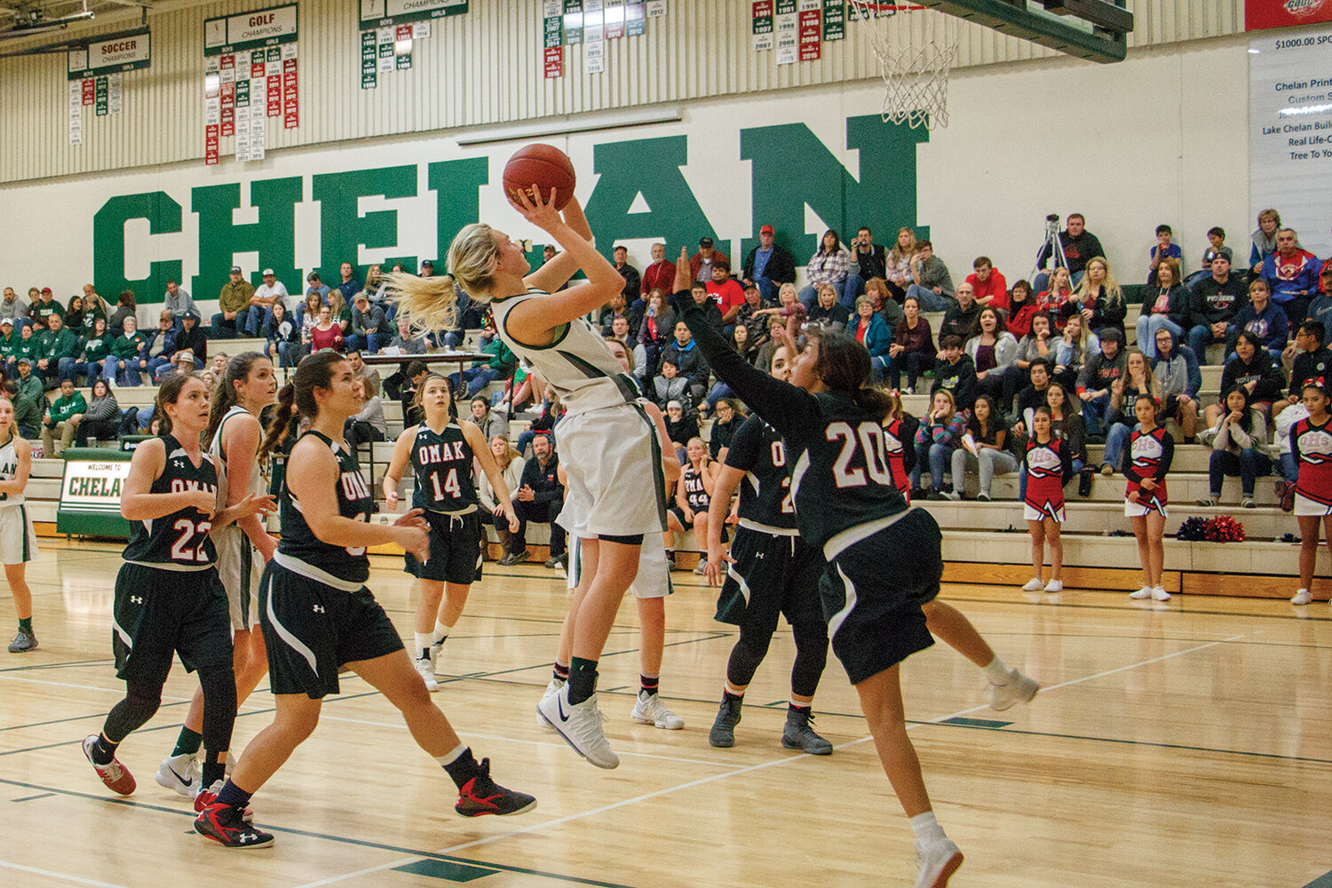 Lexie Gleasman pushes through a cluster of Omak defense for an inside jump shot.