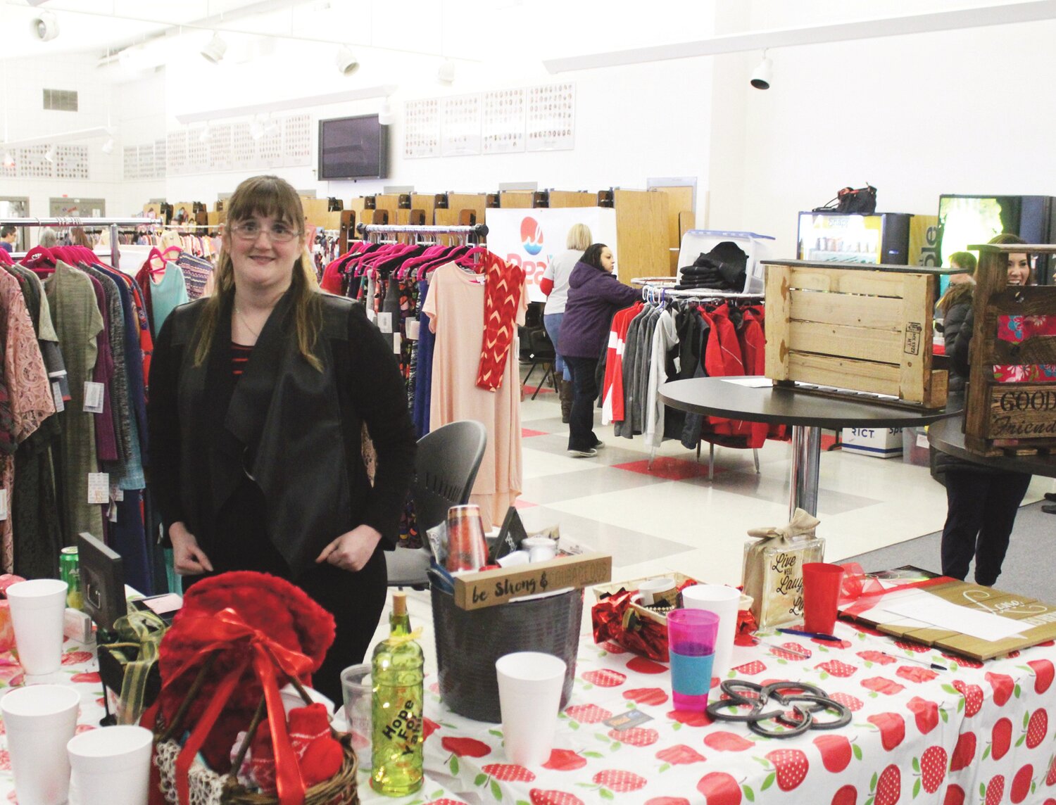 Jamie Descoteaux, a nurse practitioner at family Health Center and a Corona family friend, organized last Sunday’s fundraiser at the Brewster High School commons room. Vendors of clothing, crafts, food and other products can be seen in the background.