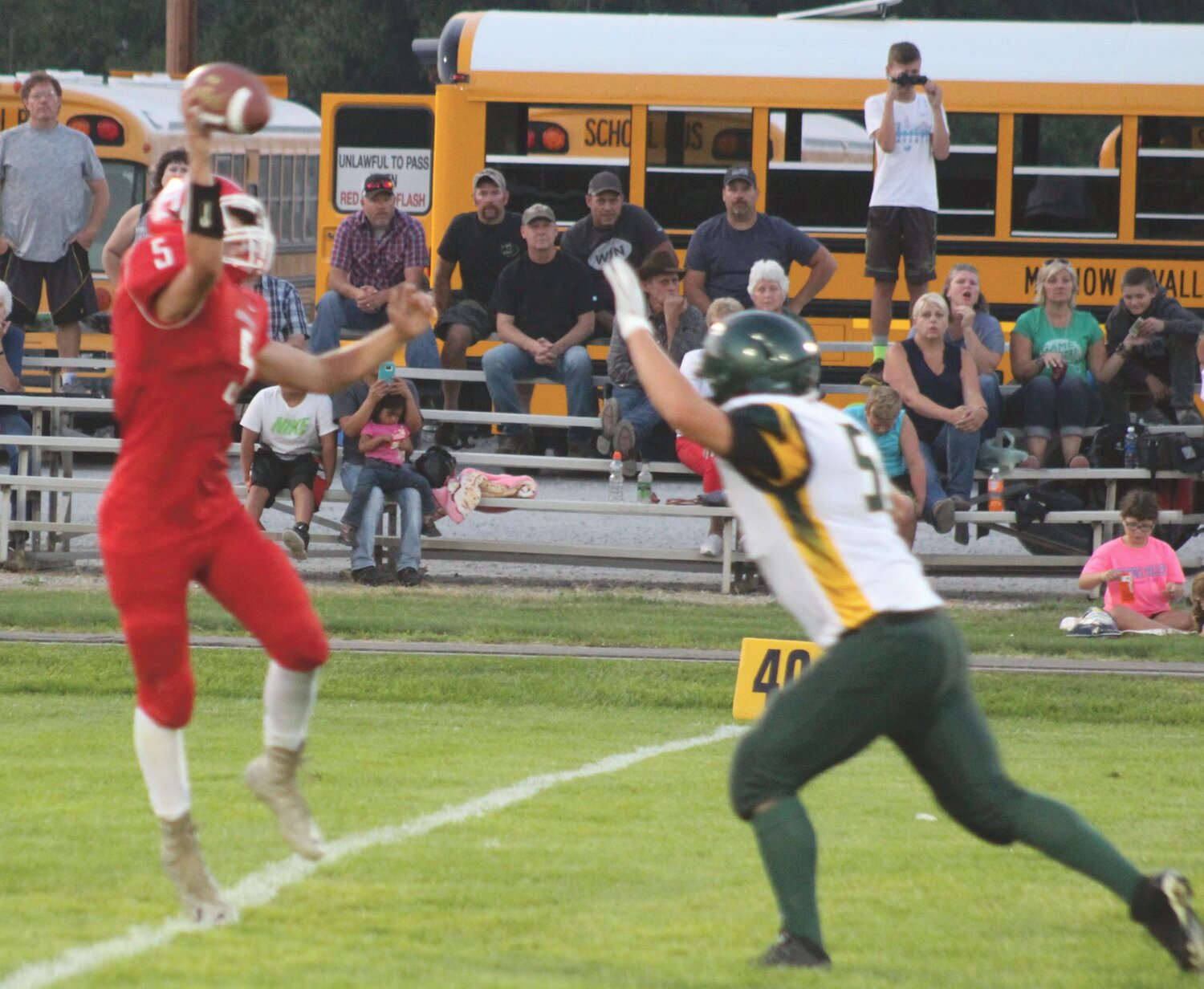 Senior quarterback Connor Wiggs goes to the air over a Liberty Bell defender.