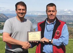 Brewster school superintendent, Eric Driessen, right, presents Jon Wyss with the WASA/ESD 171 Community Leadership Award at Gamble Sands.