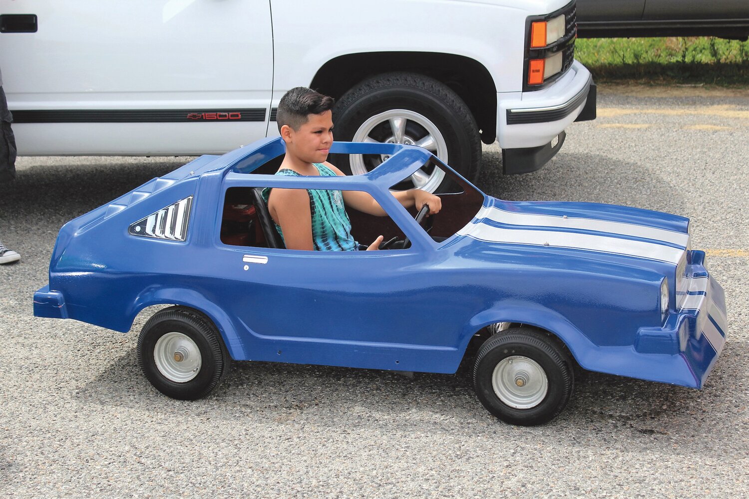 Nine-year-old Adrian Sanchez in a car just his size.