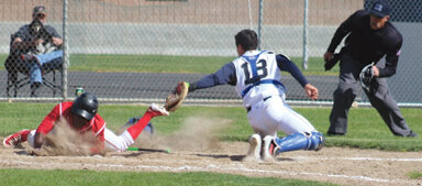 Despite his base-running speed, Jeff Sonneman is tagged out at home plate by the Tri-Cities Prep catcher.
