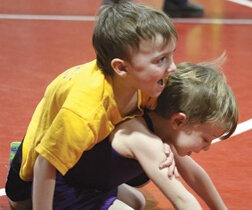 Pateros wrestlers Bentley Copenhaver, 4, in yellow, and Koye Carrington, look like they are having fun.